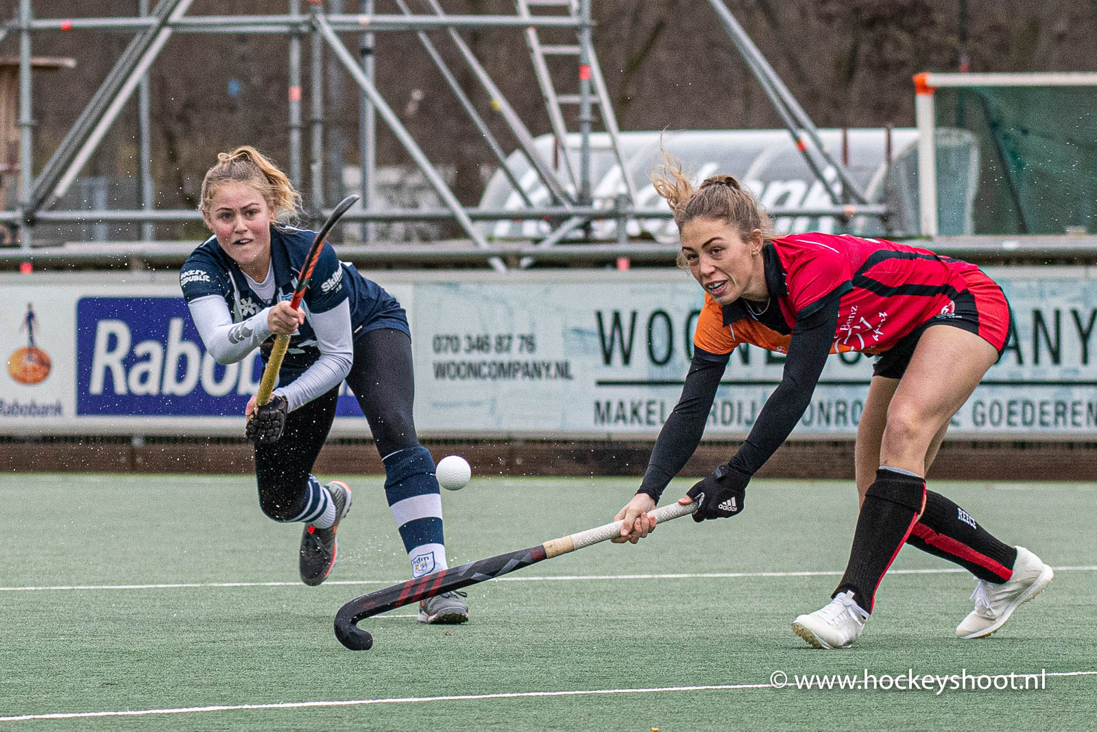 Mascha Sterk (hdm) omzeilt de blok van Laura Nunnink (Oranje Rood)